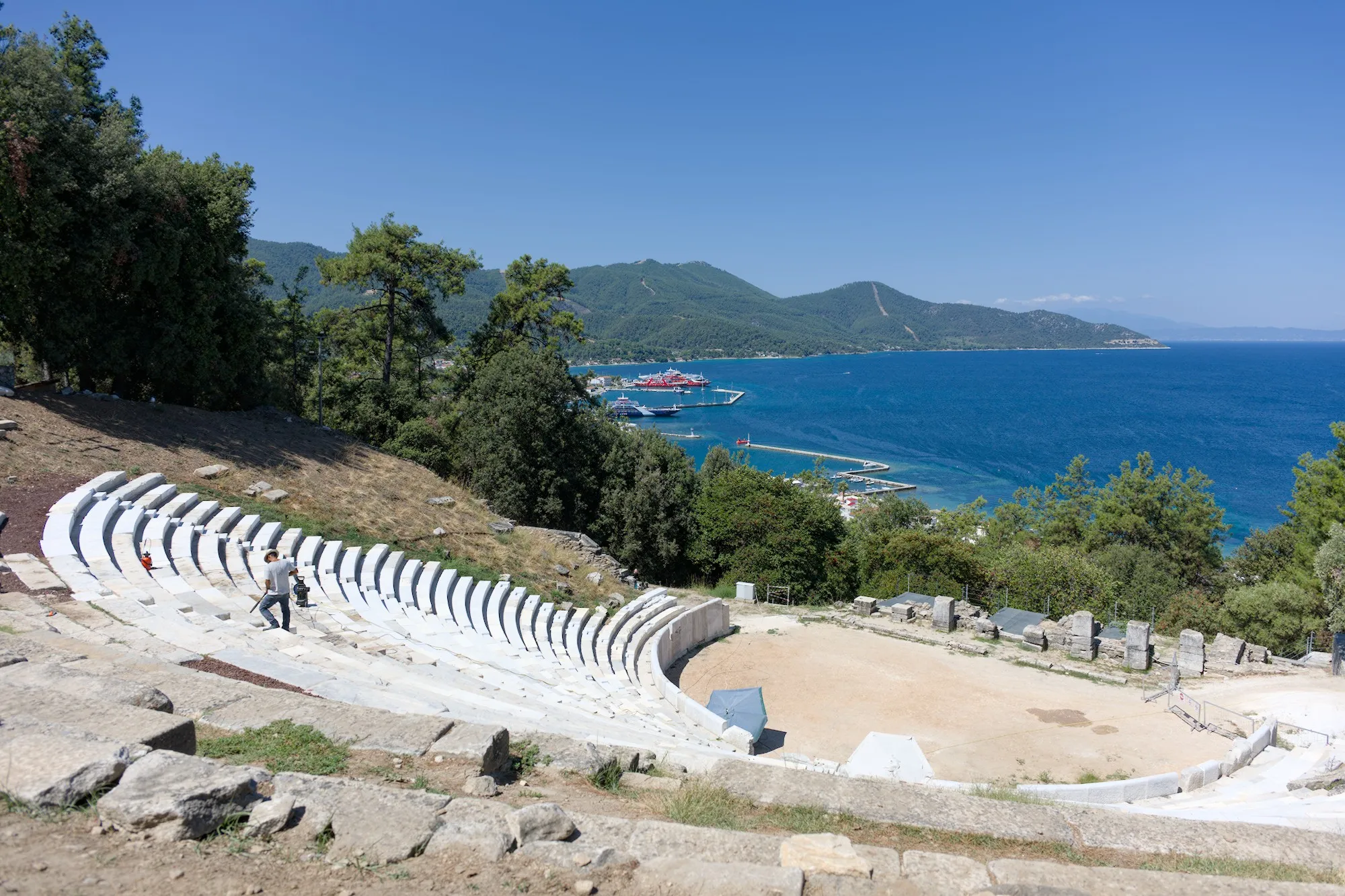 The ancient theater was being renovated, but visitors were allowed in. In the background, we can see the port of Limenas with the ferries.